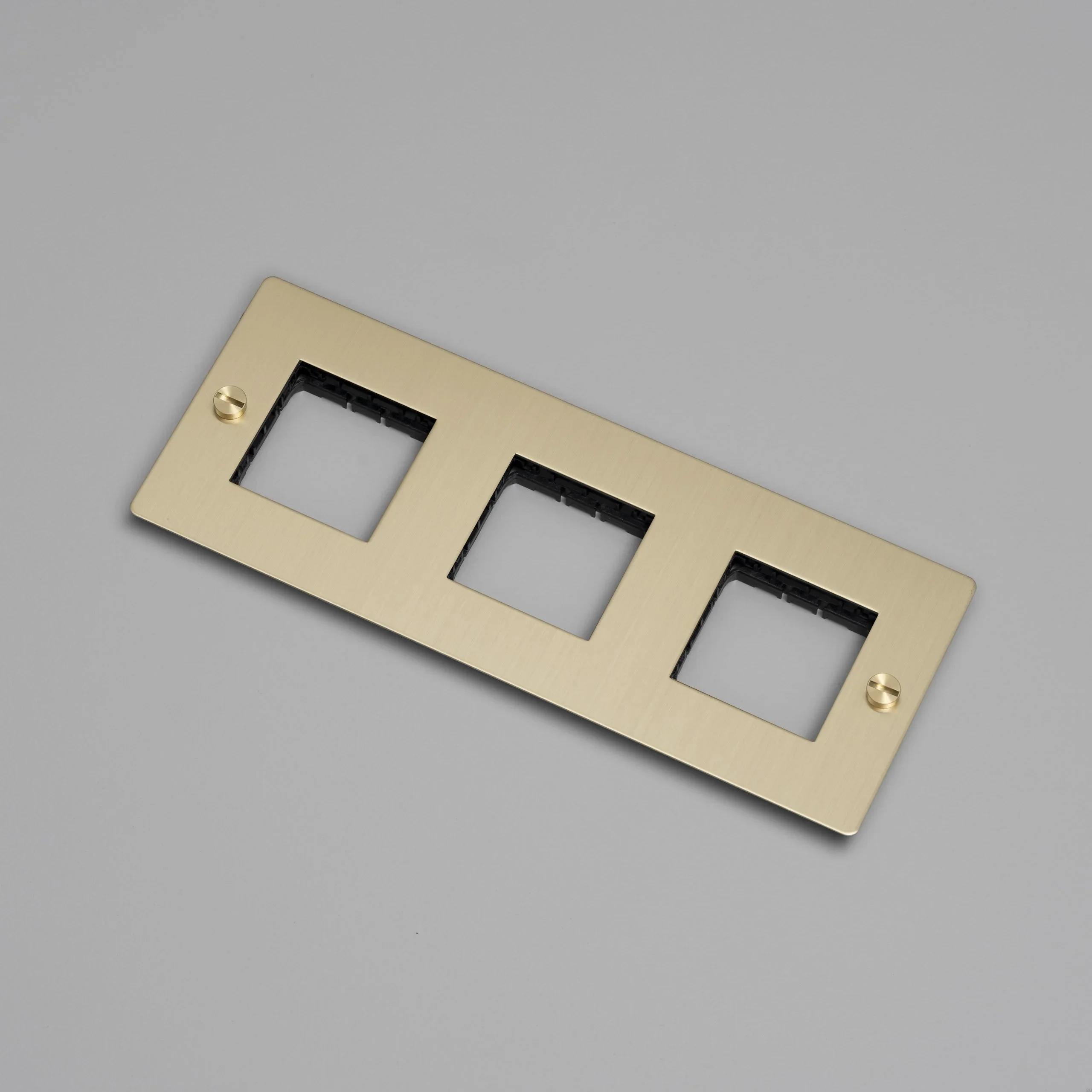 EU_ELECTRICITY_3G_Wall_Plate_No_Infill_Brass_Web-scaled.webp