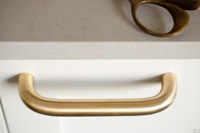 Grip 143 elongated furniture handle, brushed brass