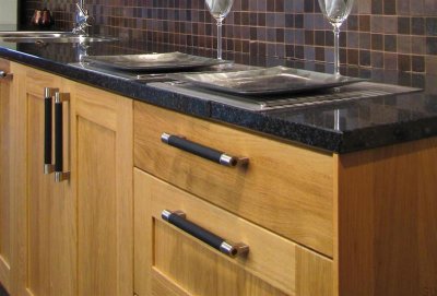 Elongated furniture handle 1700 128 Brushed nickel with black leather