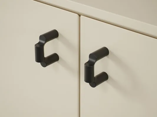 Matte black handles on beige cabinet fronts