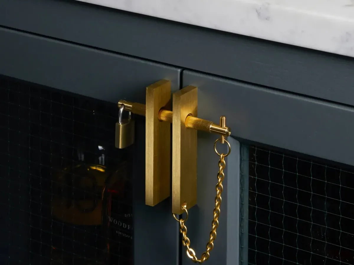 Brass handle with a latch on a cabinet