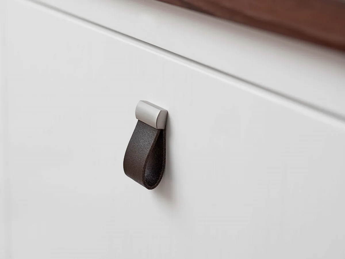 Leather handle on a white drawer