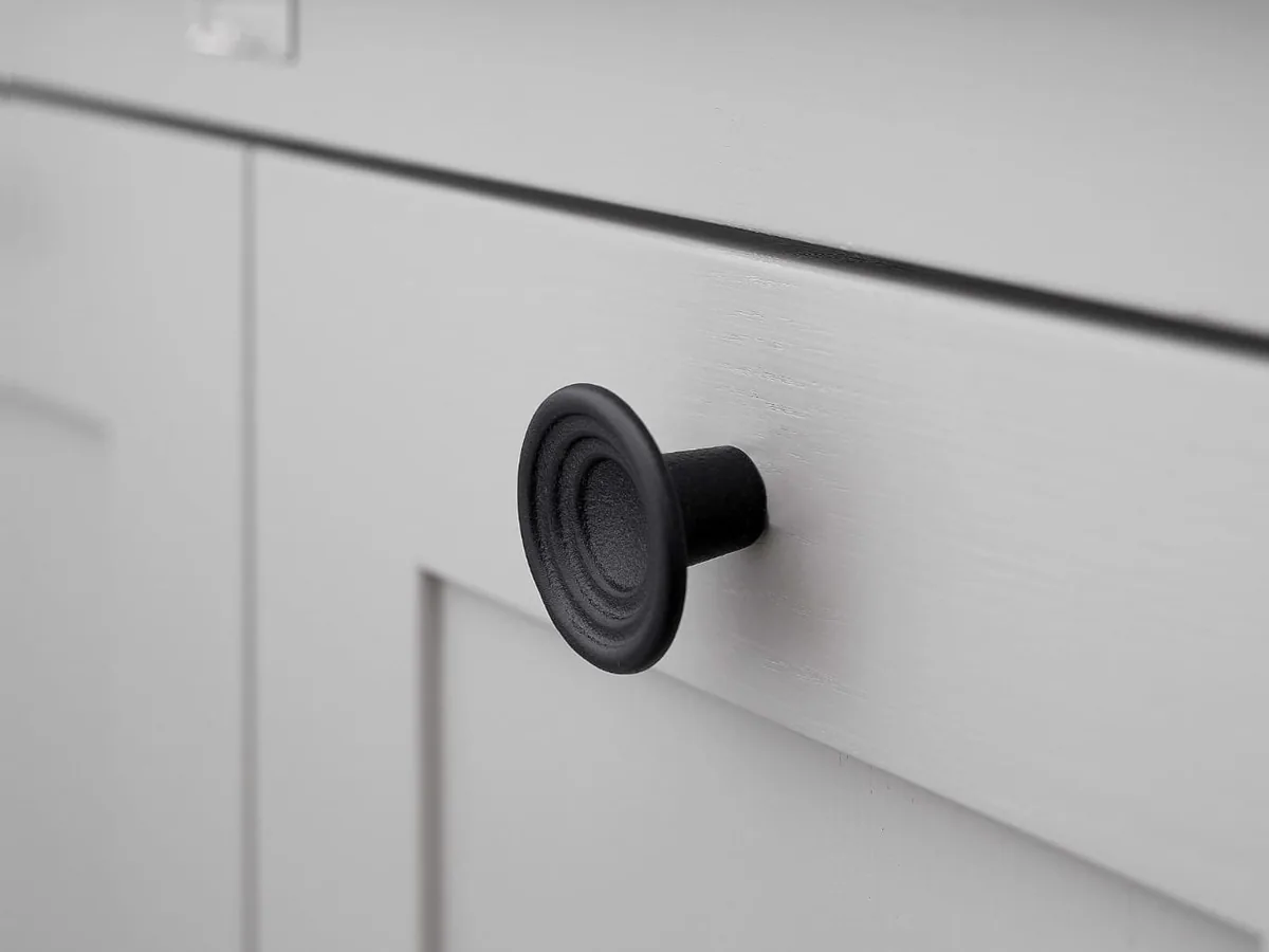 Cast iron knob on a kitchen cabinet front